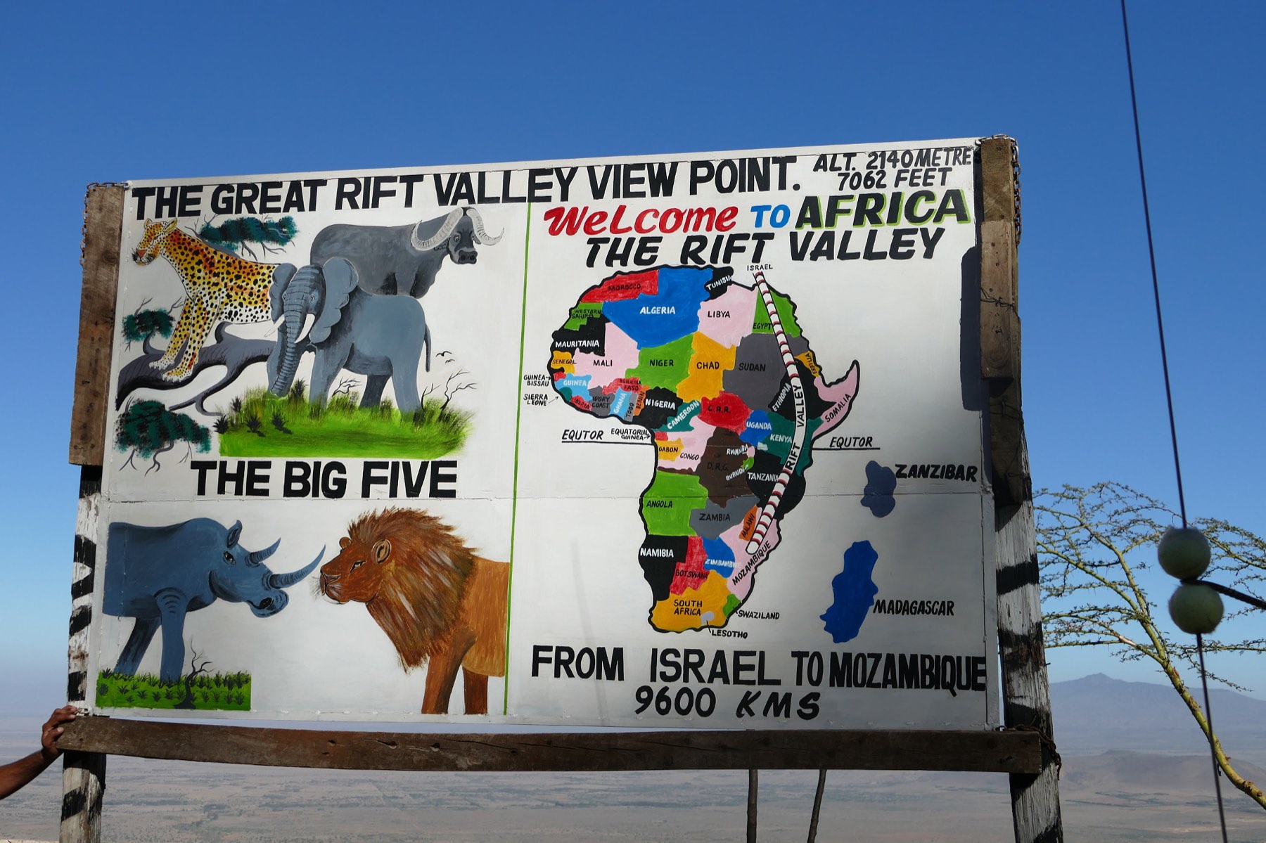 A hand-painted sign reading The Great Rift Valley View Point, altitude 2,140 metres
